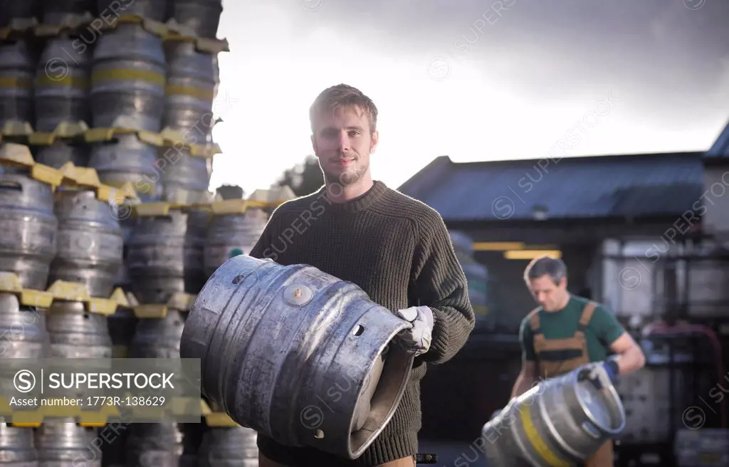 Workers with barrels outside brewery