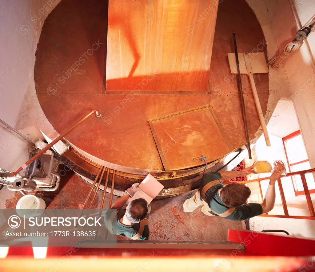 Workers with sample at copper tank