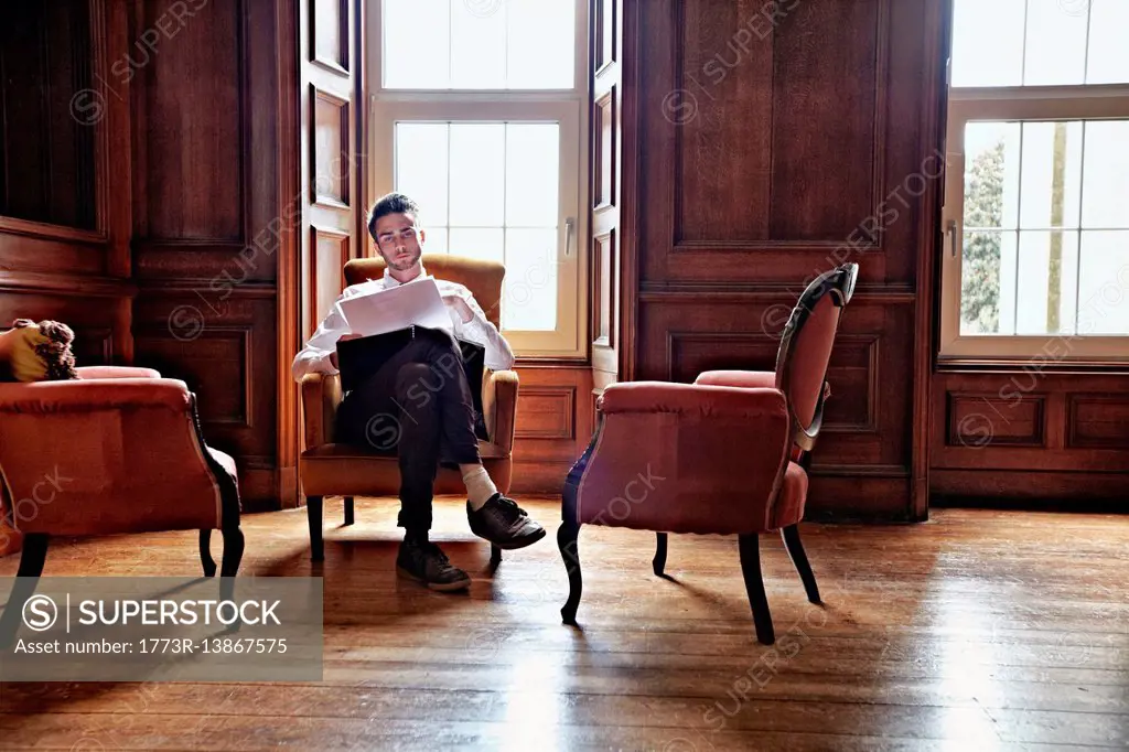 Businessman sitting in ornate room