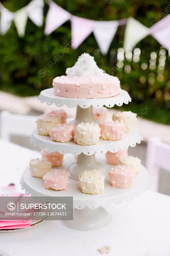 Tiered platters of cupcakes and cake