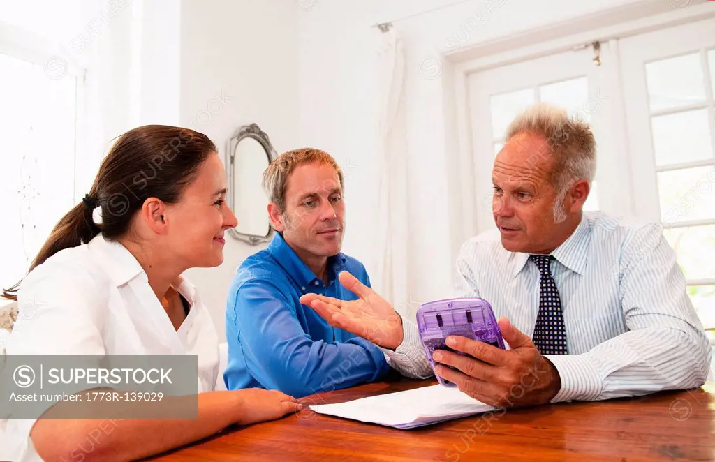 Salesman in discussion with couple