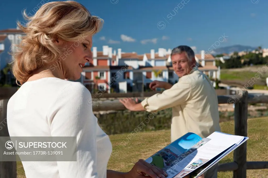 Mature woman studying realestate booklet