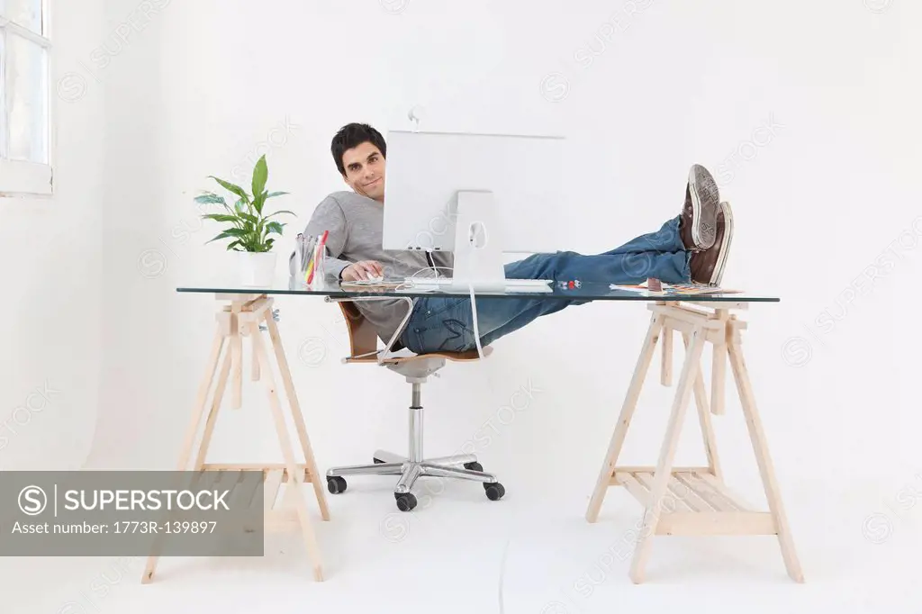Man working at computer with his feet up