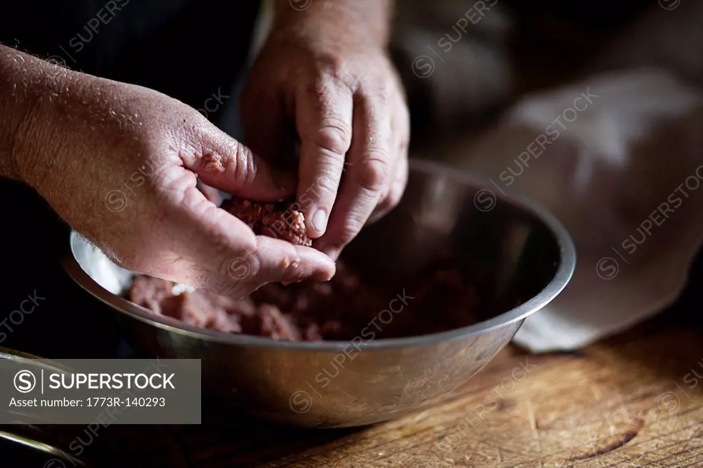Hands forming meatball