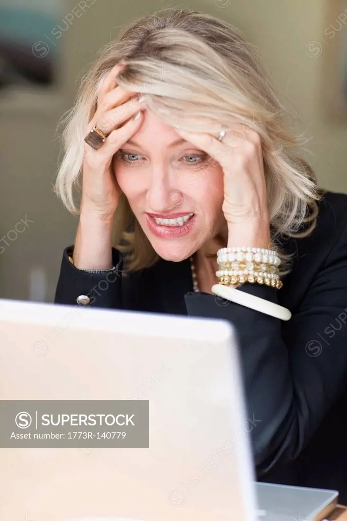 Frustrated businesswoman using laptop