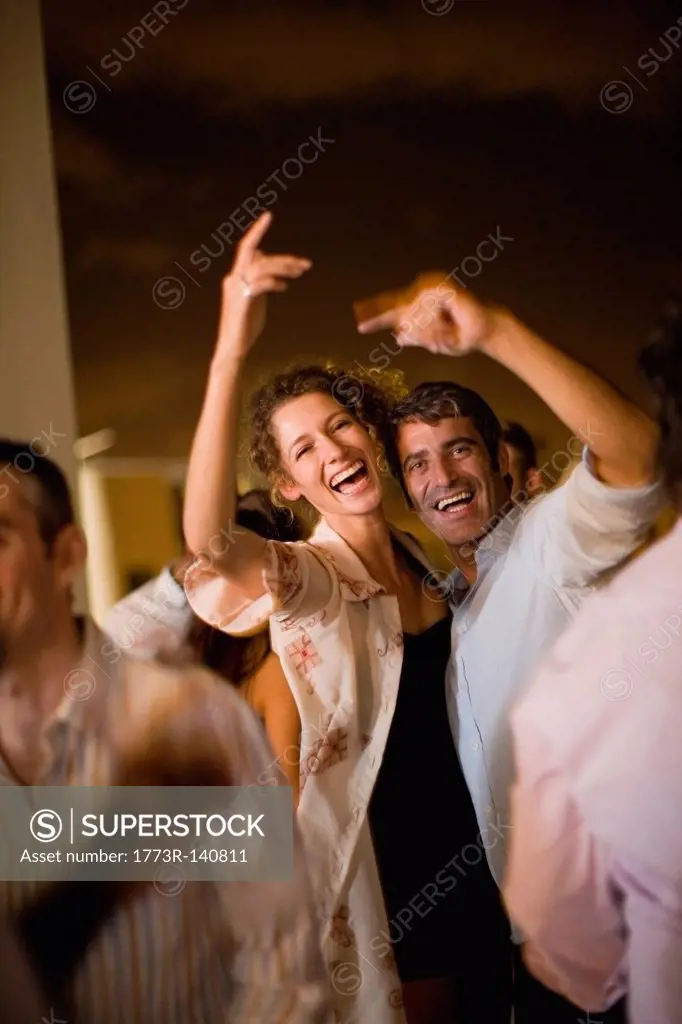 Couple dancing at party at night