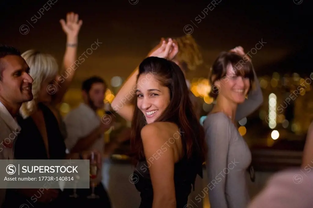 Woman dancing at party at night