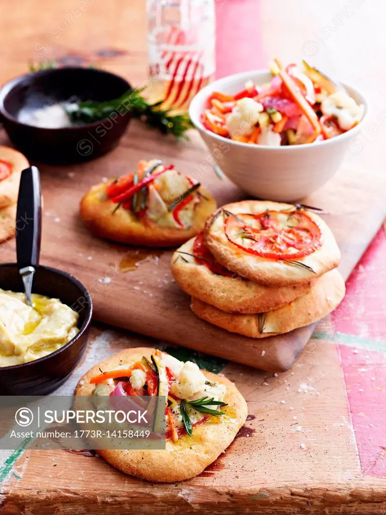 Mini pizza bread topped with giadineira, on chopping board