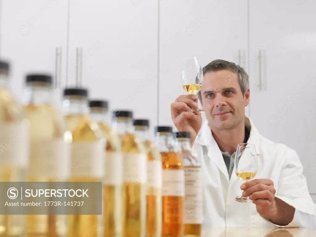 Scientist tasting whisky in plant