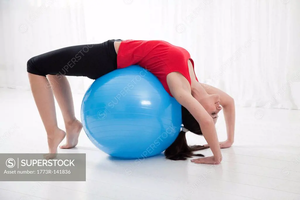 Woman stretching on exercise ball