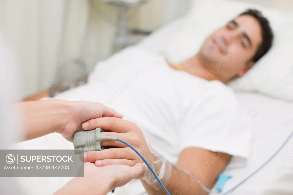 Person holding hospital patients hand