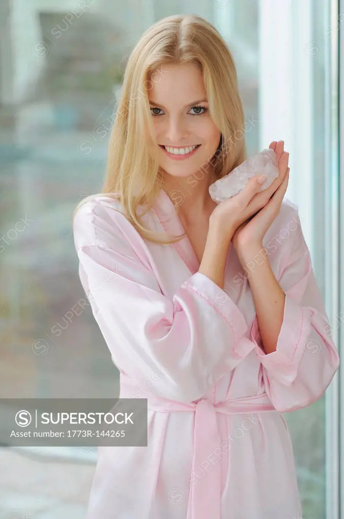 Smiling woman holding rose quartz