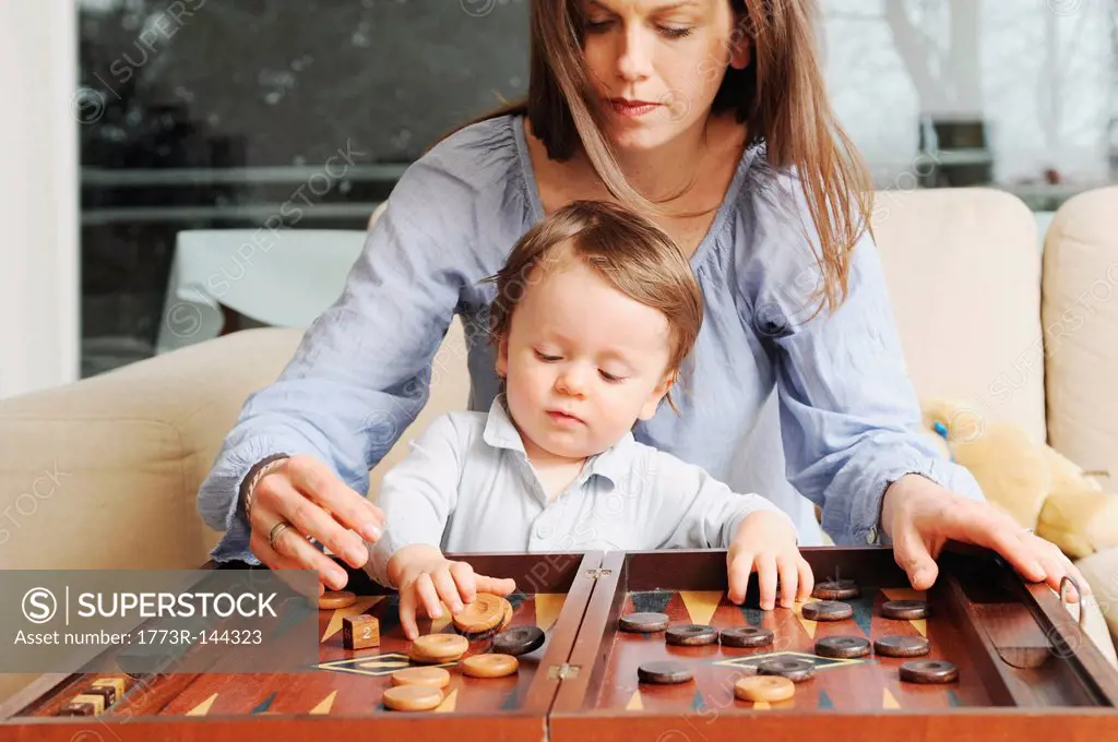Mother and son playing backgammon