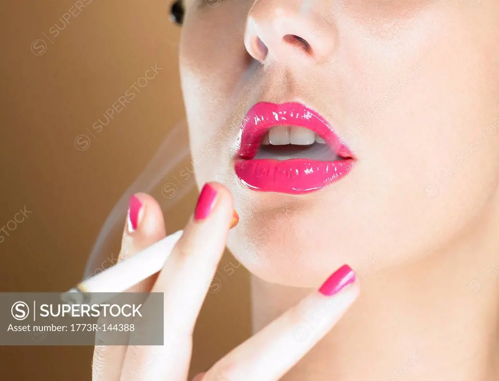 Woman in pink lipstick smoking