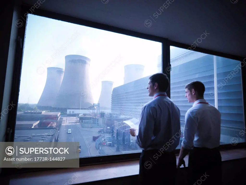 Workers looking out over power station