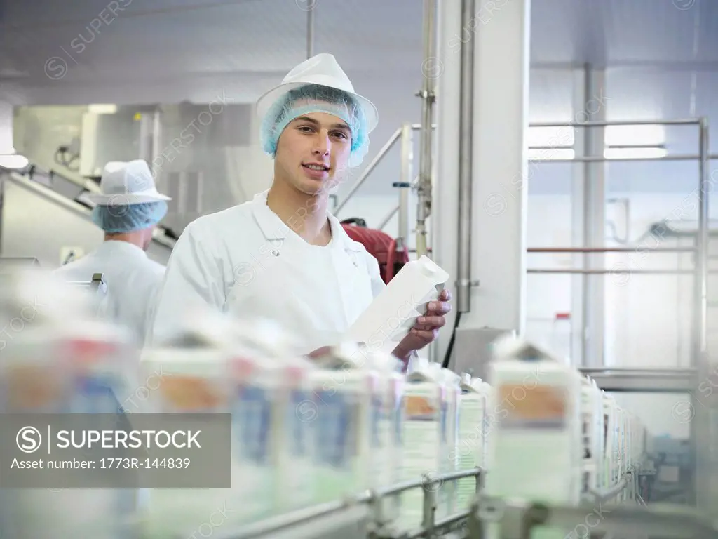 Worker inspecting goat´s milk in dairy