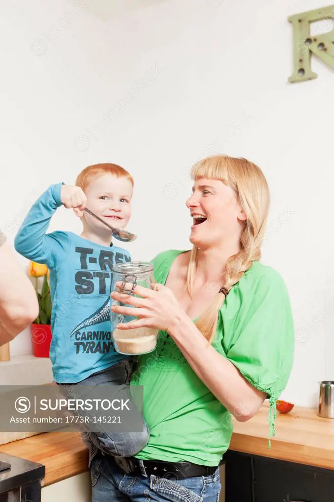 Mother and son eating in kitchen
