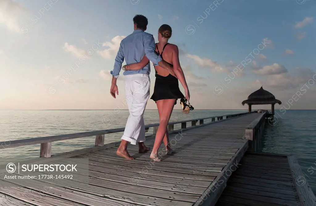 Couple walking together on dock