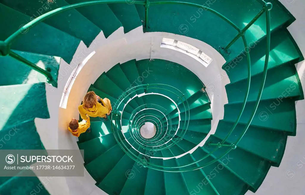 Overhead view of mother and son on spiral staircase, Tavares, Rio Grande do Sul, Brazil, South America