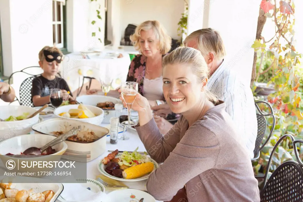 Family eating at table outdoors