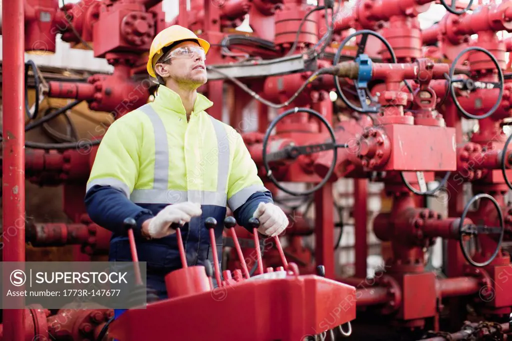 Worker operating machinery on oil rig