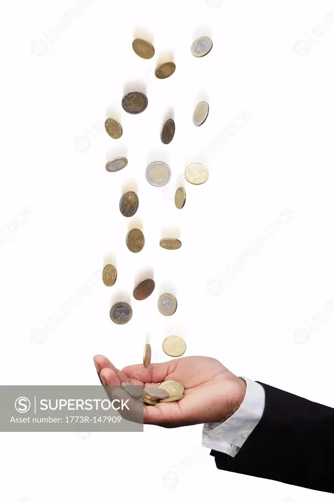 Businessman tossing Euro coins