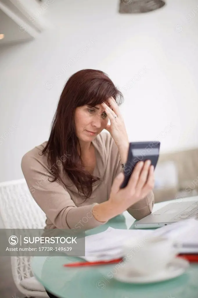 Woman paying her bills at home