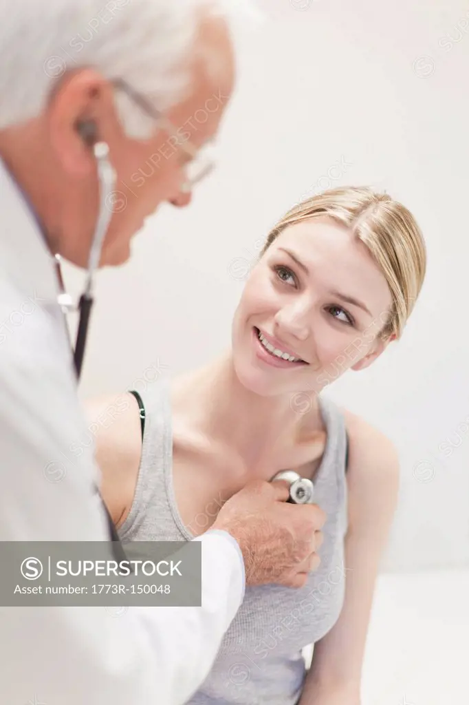 Doctor listening to patients heartbeat