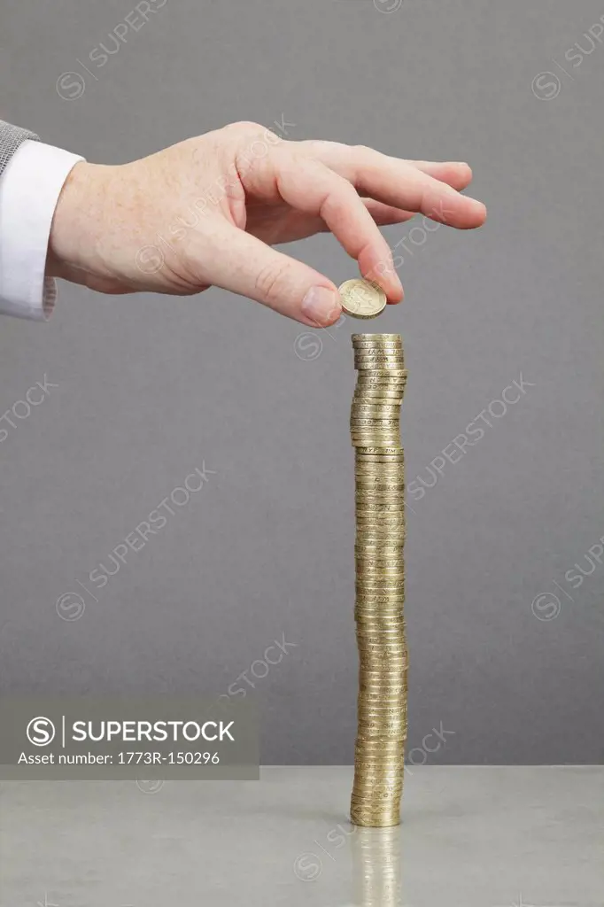 Businessman making stack of coins