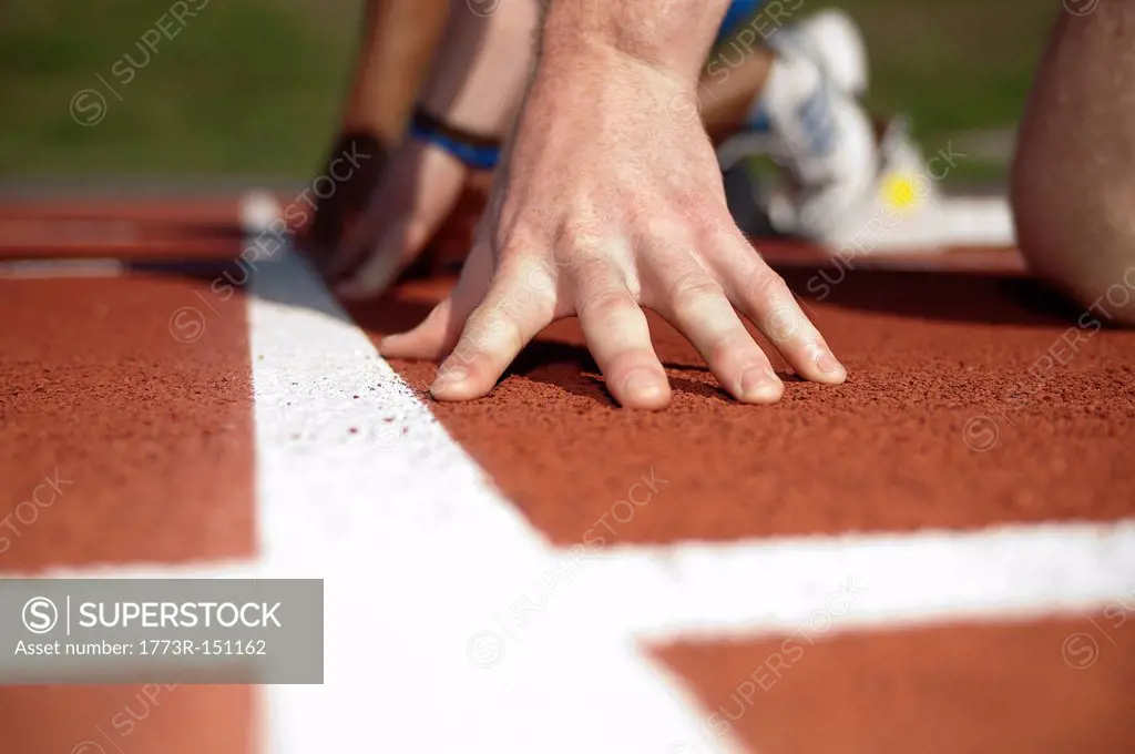 Close up of athlete´s hand on track