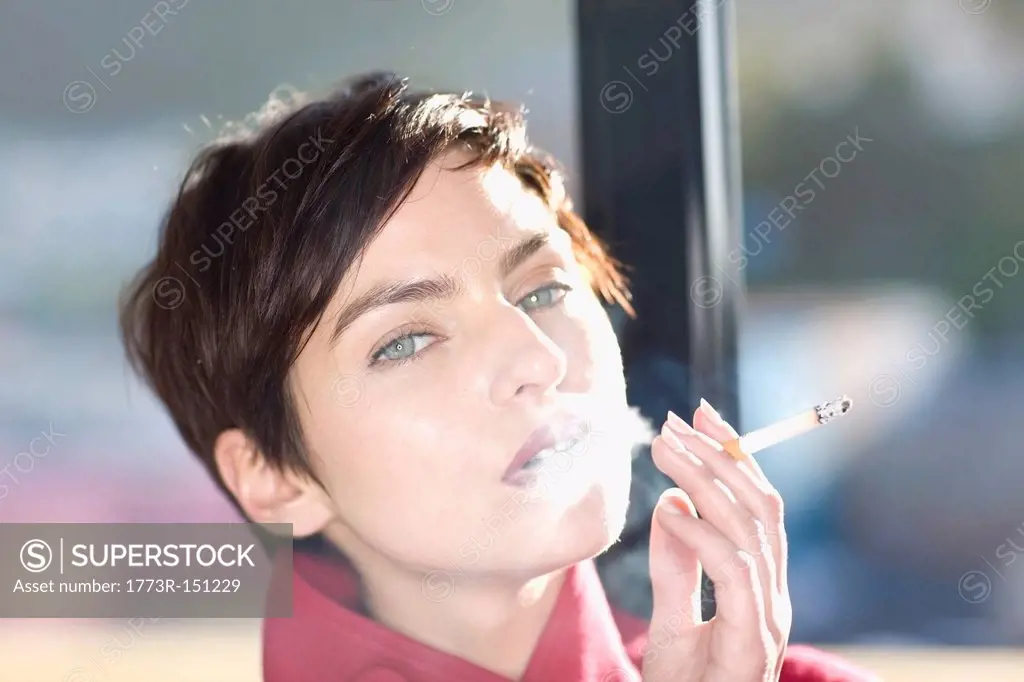 Woman smoking cigarette outdoors