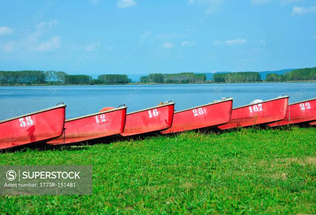 Numbered boats docked by lake