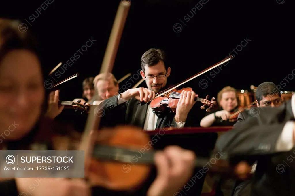 Violin players in orchestra