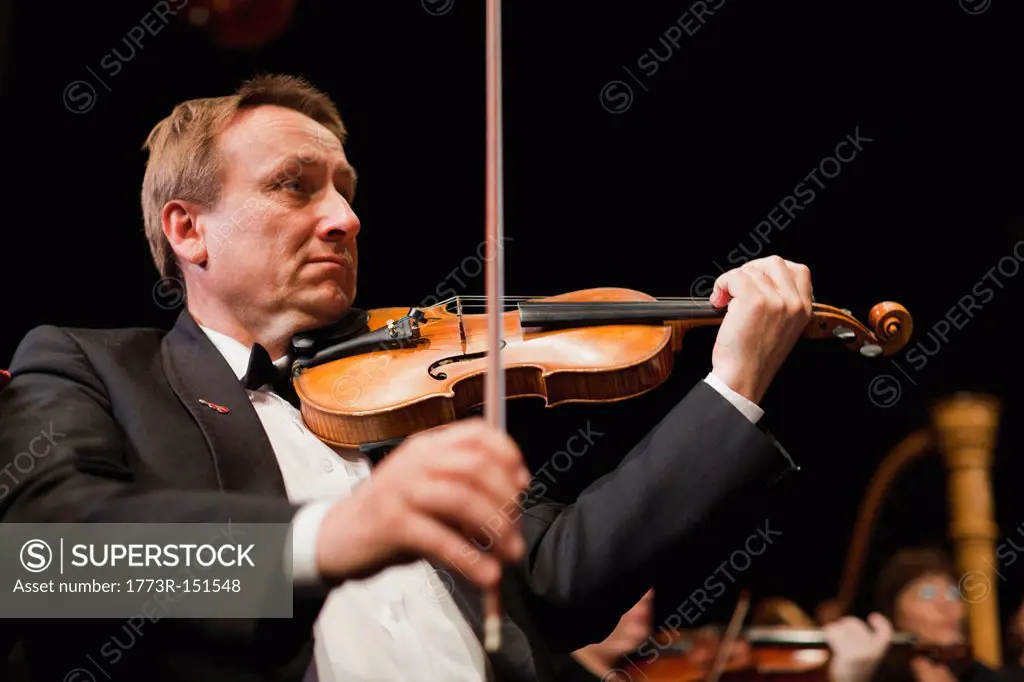 Violin player in orchestra