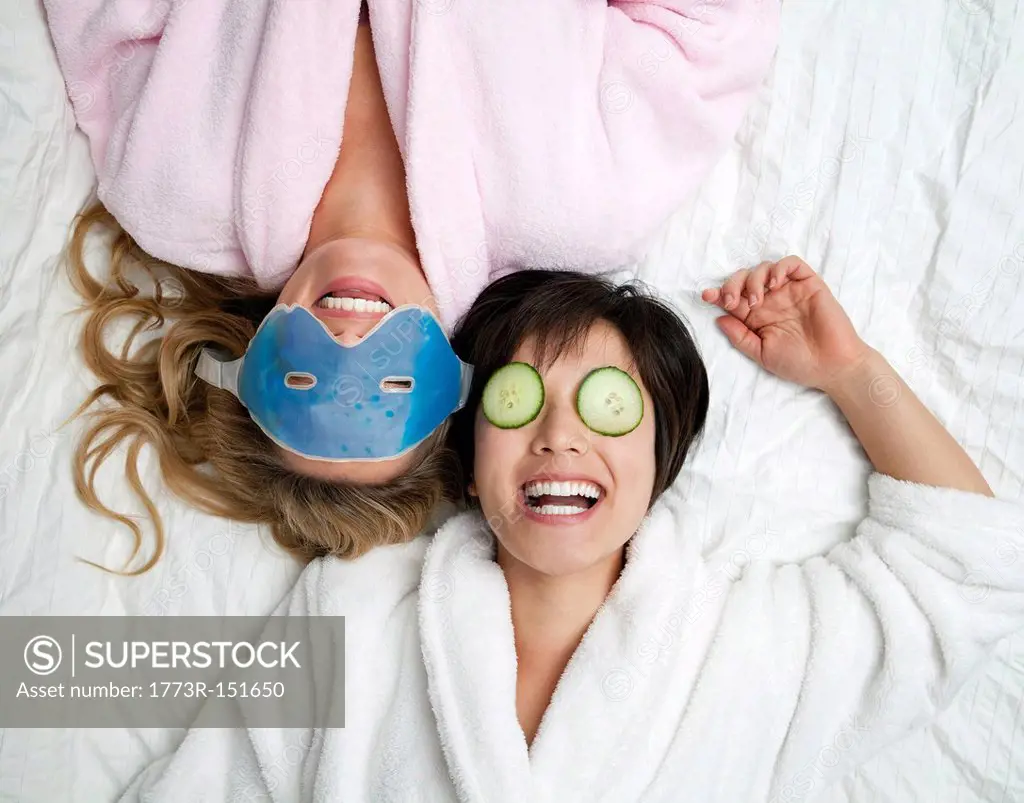Women in bathrobes wearing eye masks