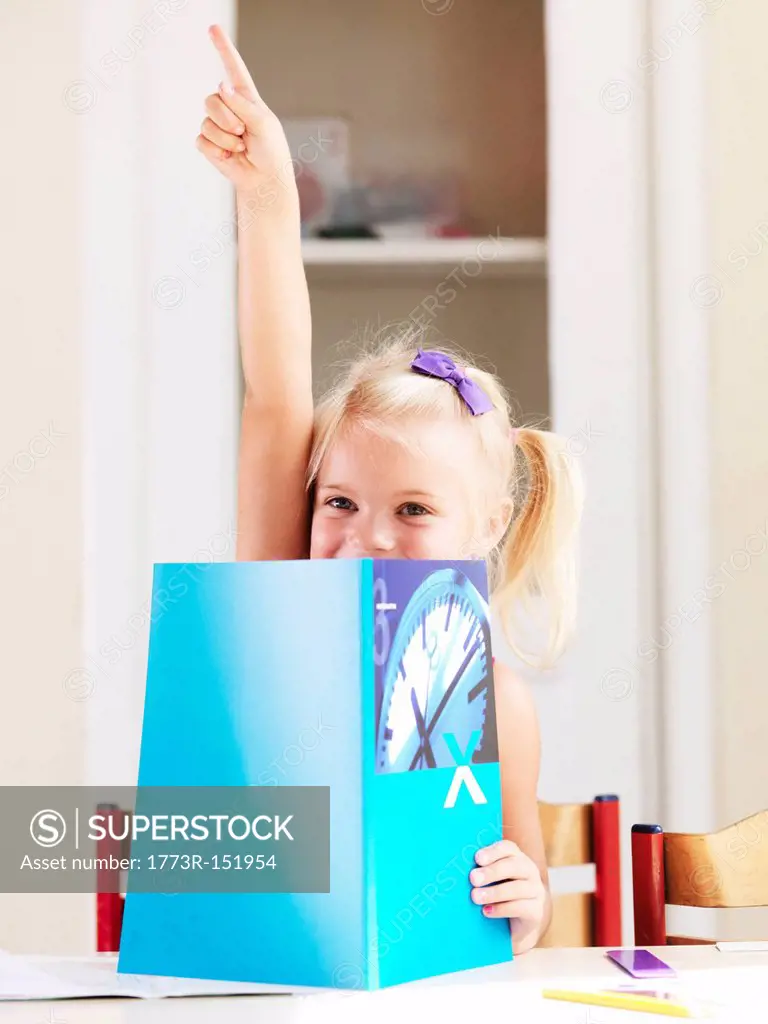 Girl reading book at desk