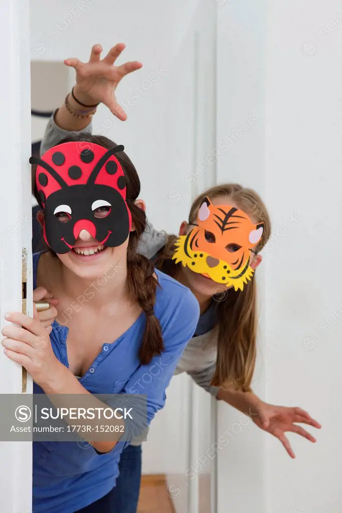 Smiling girls wearing colorful masks