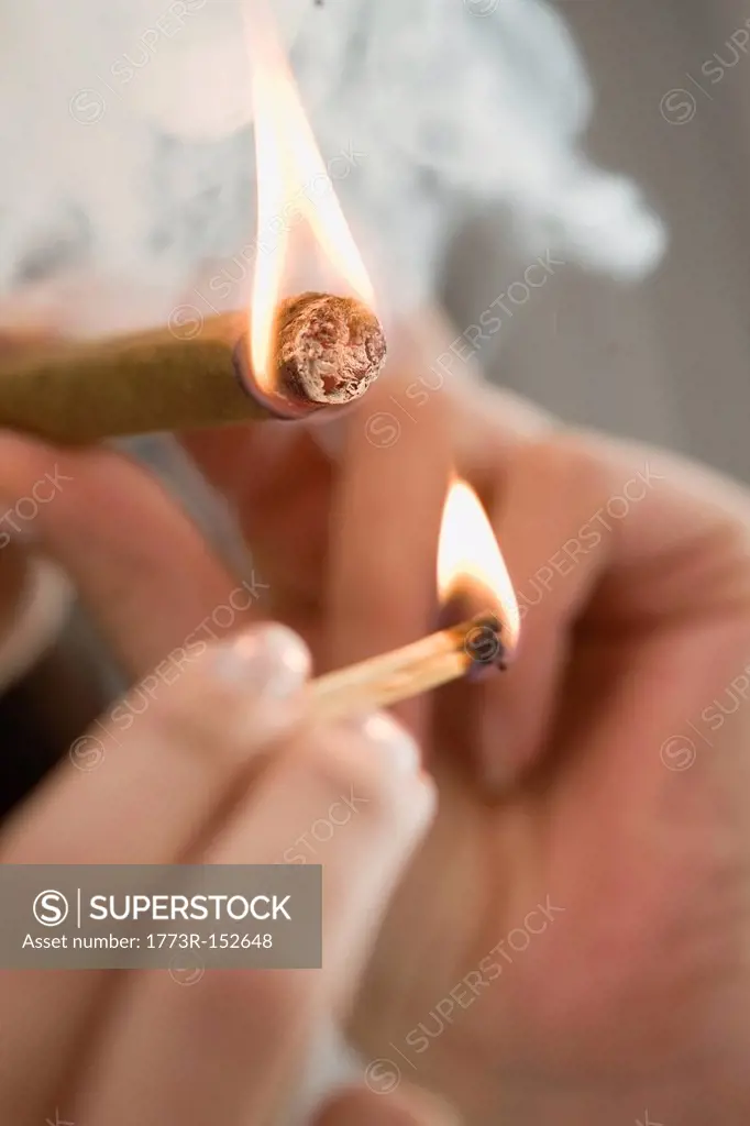 Close up of woman lighting cigarette