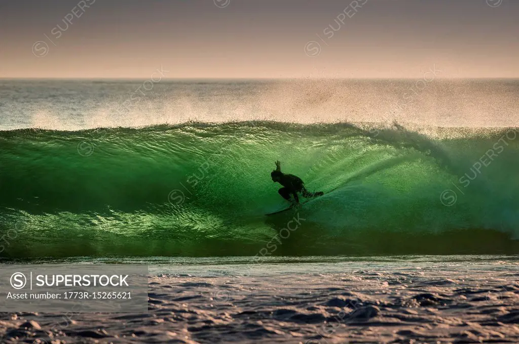 Surfer surfing on barreling wave, Crab Island, Doolin, Clare, Ireland