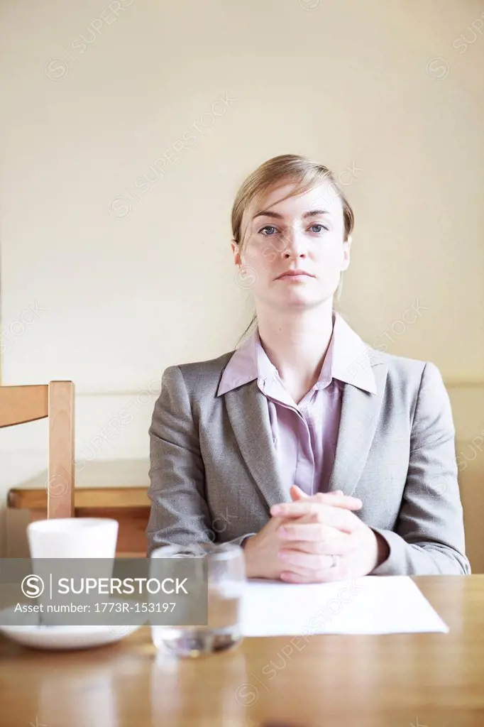 Serious businesswoman sitting in cafe