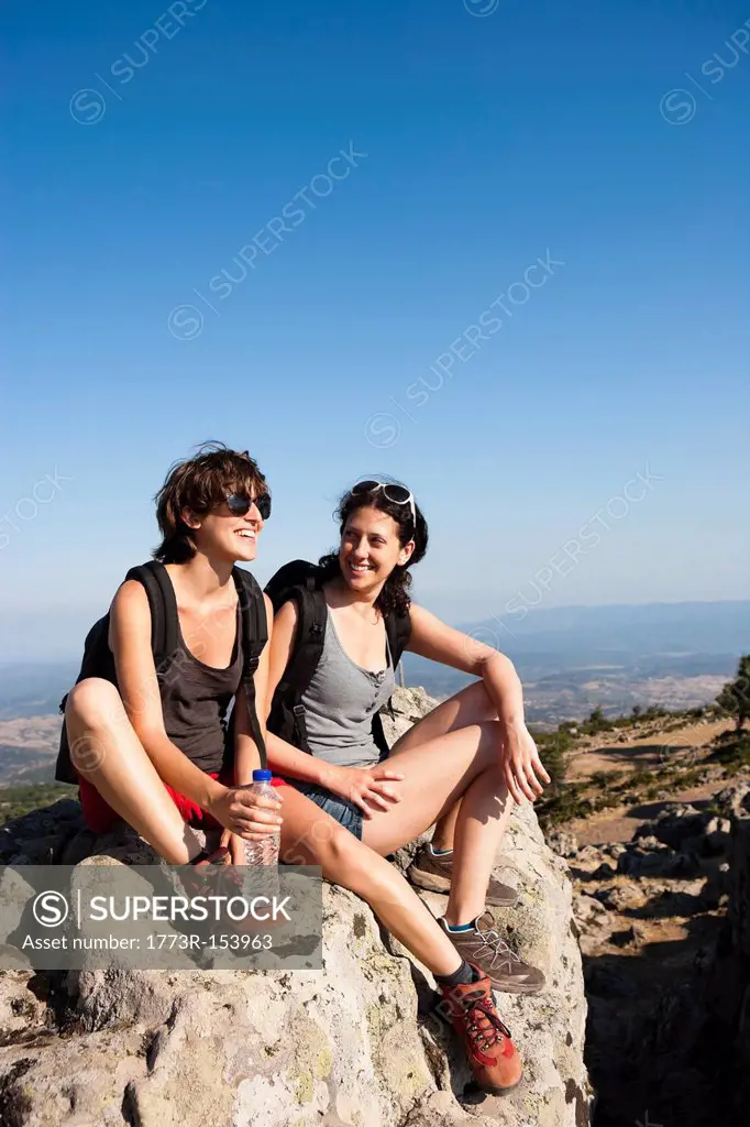 Hikers resting on rocks on hill