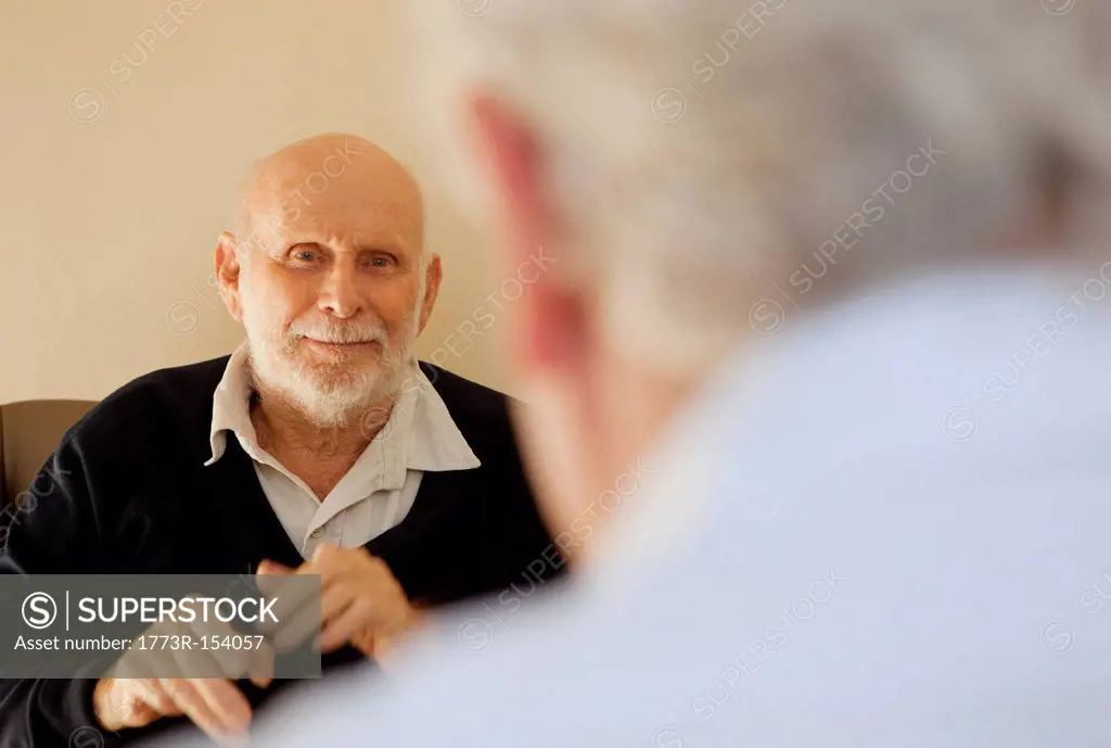 Older men talking indoors