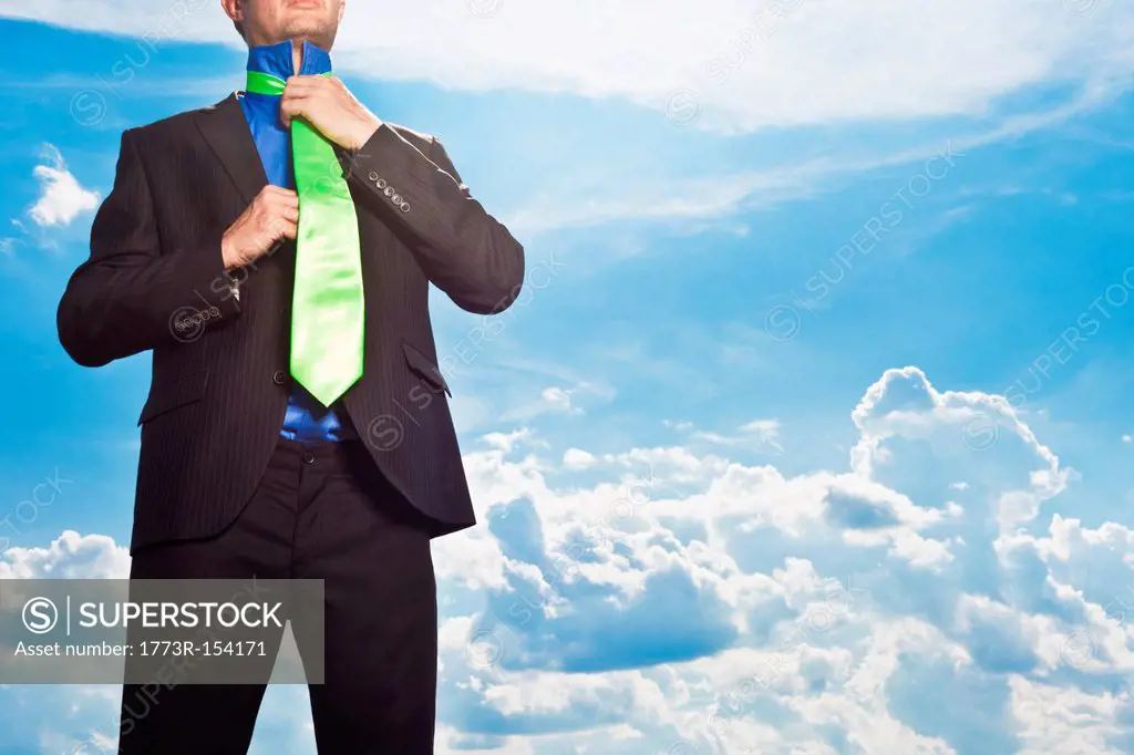 Businessman tying his tie outdoors