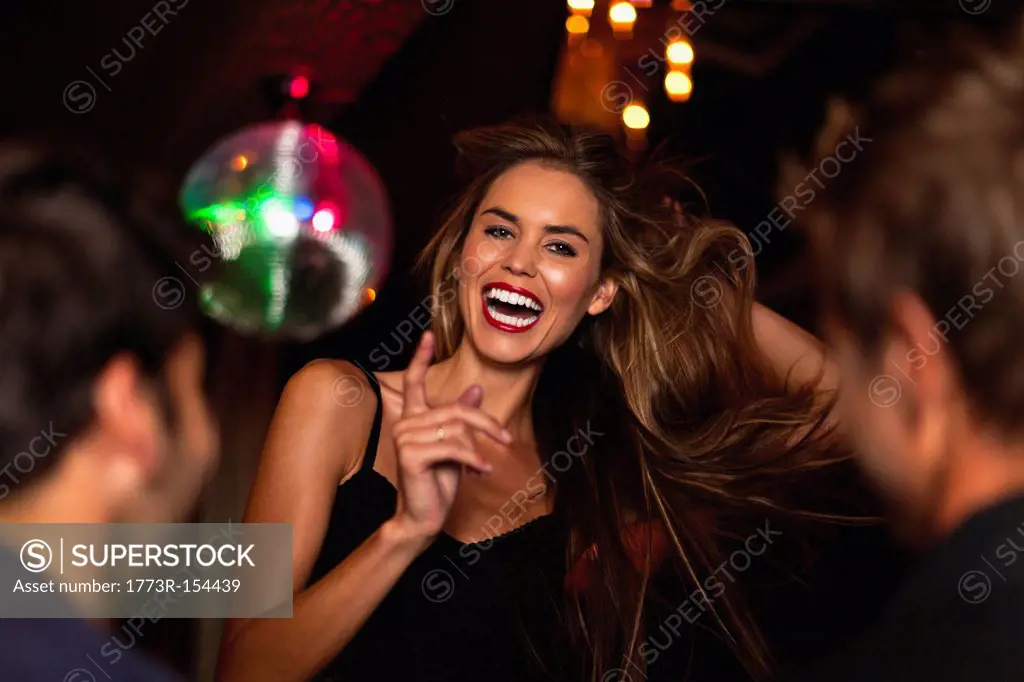 Smiling woman dancing in club