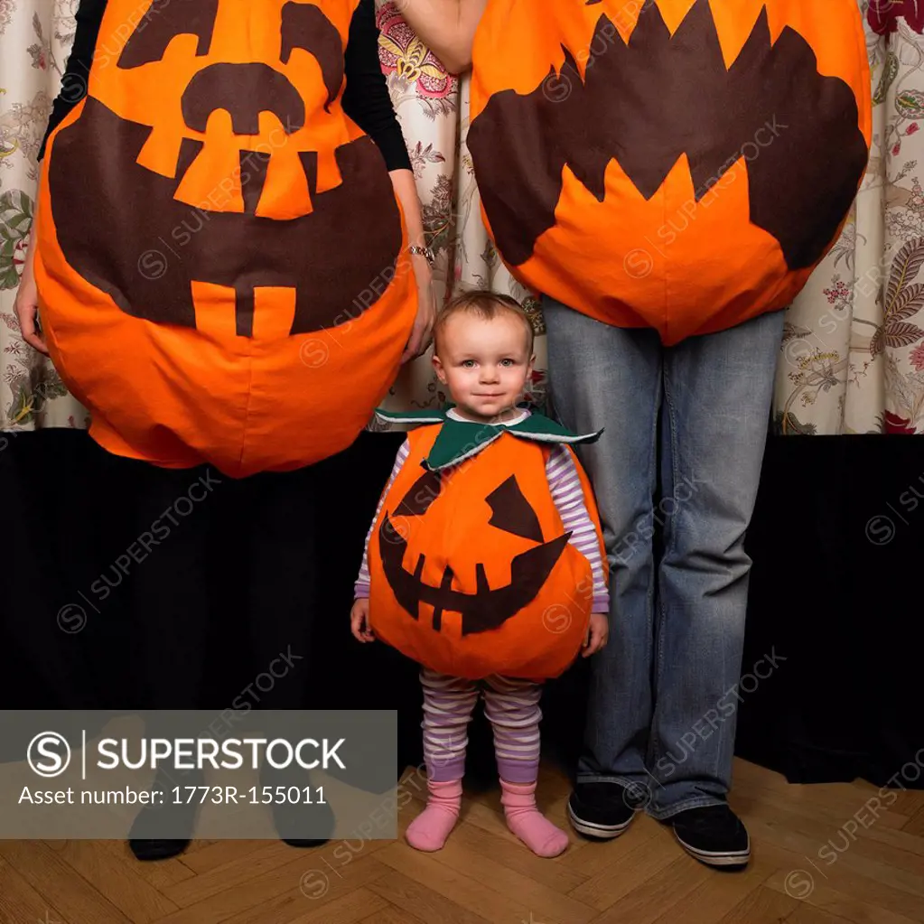 Family dressed as pumpkins for Halloween