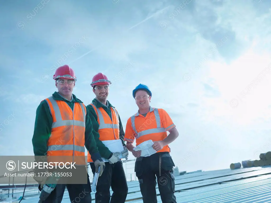 Workers standing together on roof