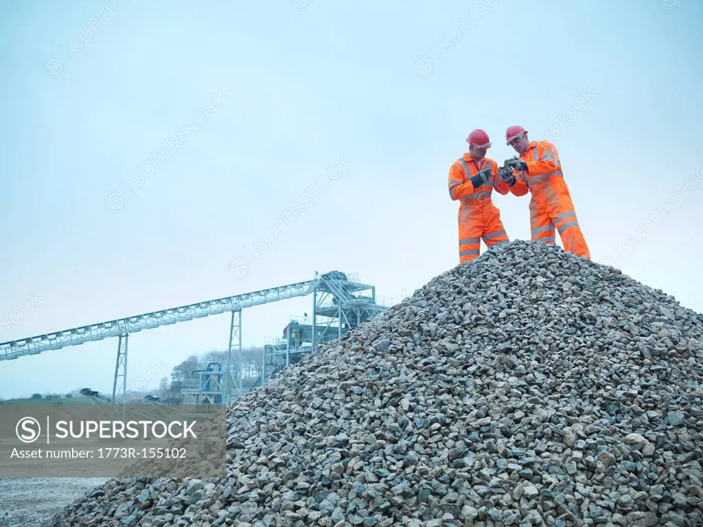 Workers inspecting quarry rocks