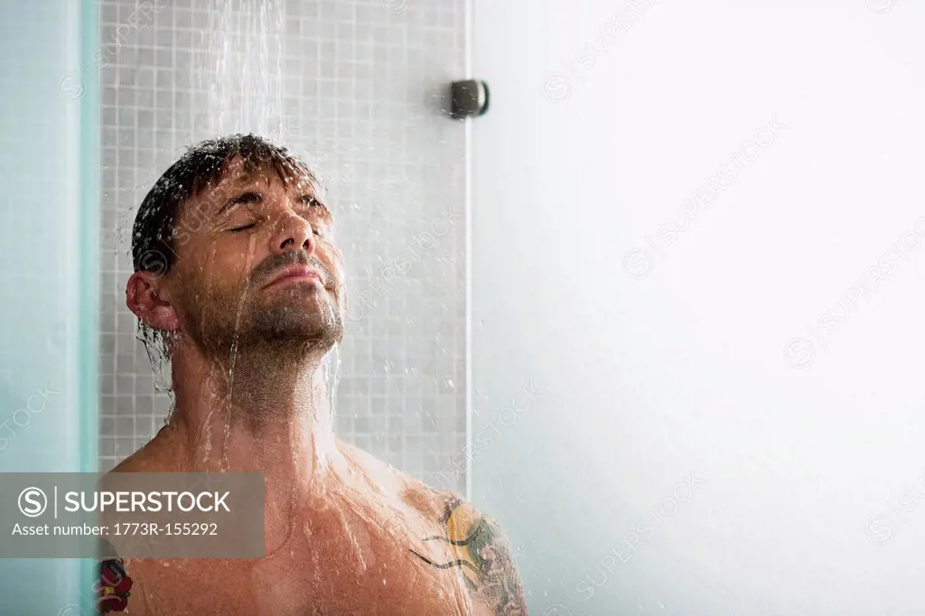 Man washing his hair in shower