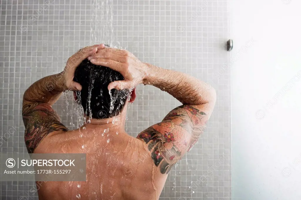 Man washing his hair in shower