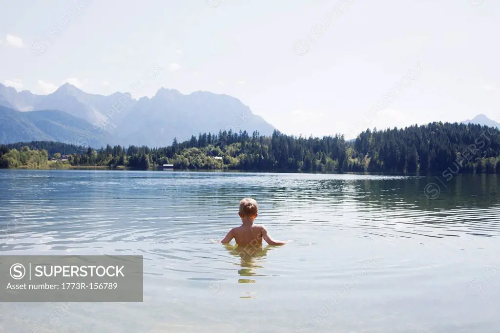 Boy swimming in lake